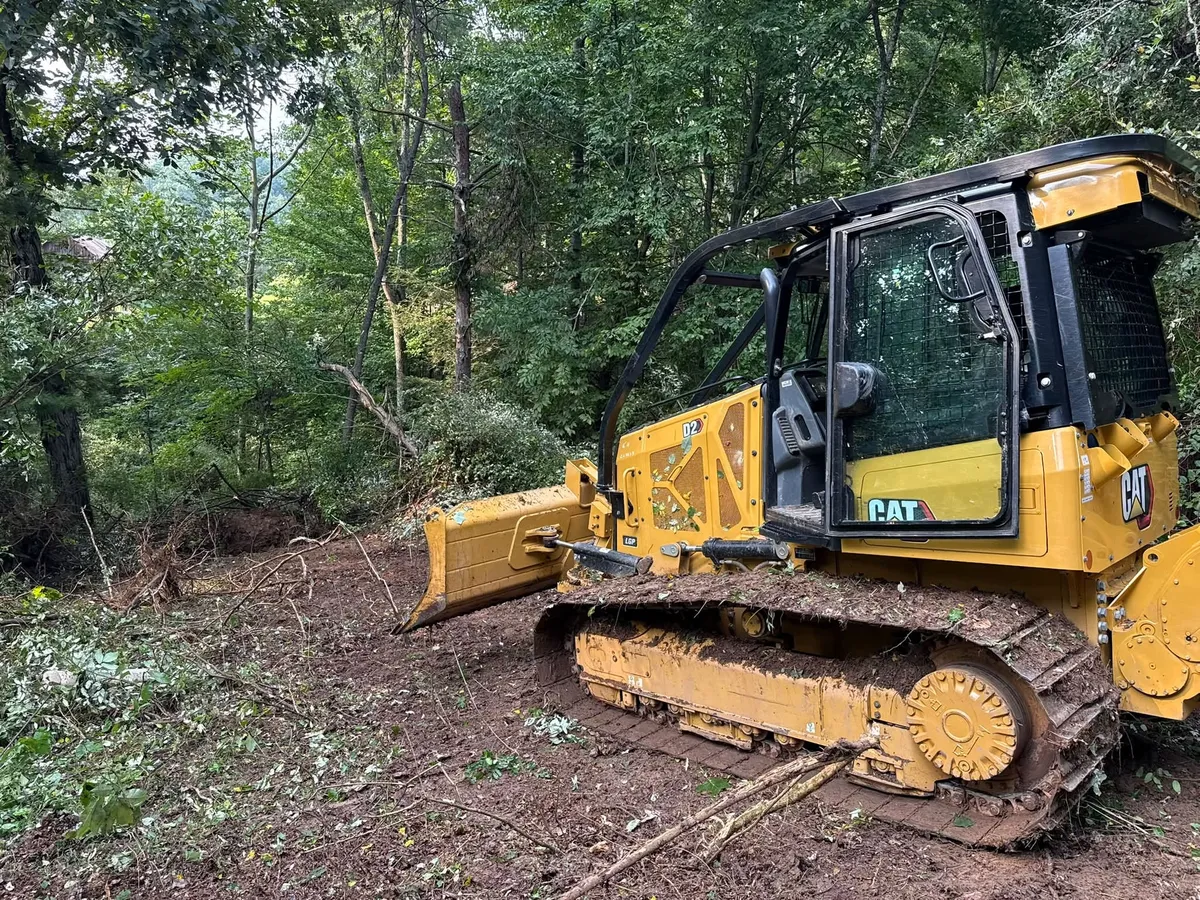 Bulldozer clearing a wooded lot for a house site