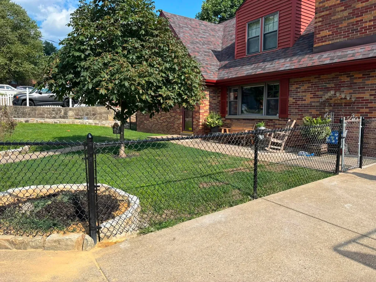 New fence installed along a brick home